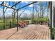 The outdoor deck features wood flooring, black metal railings, and a scenic backyard view at 17420 Dalton Ct, Noblesville, IN 46062