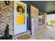 Inviting front porch with brick accents, yellow door, and cozy decor at 17420 Dalton Ct, Noblesville, IN 46062