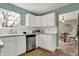Well-lit kitchen featuring white cabinetry, stainless steel appliances, and a view into the dining area at 17420 Dalton Ct, Noblesville, IN 46062