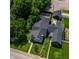 Aerial view highlighting the home's roof deck, yard, and proximity to lush greenery at 1818 N Cornell Ave, Indianapolis, IN 46202