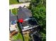 Aerial view showcasing a rooftop patio with seating, a vibrant red umbrella, and lush landscaping at 1818 N Cornell Ave, Indianapolis, IN 46202