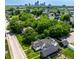Aerial view of a home nestled among lush greenery with the downtown city skyline in the distance at 1818 N Cornell Ave, Indianapolis, IN 46202