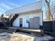 Backyard featuring a deck, stairs, external storage, and black fence at 1818 N Cornell Ave, Indianapolis, IN 46202