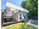 Backyard with a wooden deck, stairs to upper level, stone feature and lush greenery at 1818 N Cornell Ave, Indianapolis, IN 46202