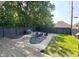 Backyard with fire pit, seating, lush landscaping, and a grill perfect for outdoor entertaining at 1818 N Cornell Ave, Indianapolis, IN 46202