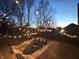 Beautiful backyard featuring string lights, a patio area with seating, and a well-maintained privacy fence at 1818 N Cornell Ave, Indianapolis, IN 46202