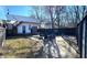 A backyard with stone, grass, chairs around a firepit, and a fence at 1818 N Cornell Ave, Indianapolis, IN 46202