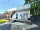 Charming backyard featuring a wooden deck, pebble feature, and stairs leading to a rooftop space at 1818 N Cornell Ave, Indianapolis, IN 46202