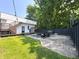 Spacious backyard with a fire pit, seating, grill, and a lush green lawn perfect for entertaining at 1818 N Cornell Ave, Indianapolis, IN 46202