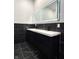 Modern bathroom features double sink vanity, black marble tile, and dual, backlit mirrors at 1818 N Cornell Ave, Indianapolis, IN 46202