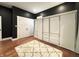 Bedroom with sleek, built-in wardrobe closet, hardwood floors and ample natural light at 1818 N Cornell Ave, Indianapolis, IN 46202