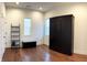 Bedroom with hardwood floors, built-in storage unit, and natural light from the window at 1818 N Cornell Ave, Indianapolis, IN 46202