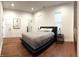Bright bedroom with a comfortable bed, dark wood floors, and large windows at 1818 N Cornell Ave, Indianapolis, IN 46202