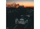A charming home at dusk with a well-lit exterior and construction in the background at 1818 N Cornell Ave, Indianapolis, IN 46202