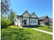 Charming two-story home with a modern door and a well-manicured lawn under a clear blue sky at 1818 N Cornell Ave, Indianapolis, IN 46202