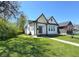 Inviting curb appeal, this home offers a well-maintained lawn and a sidewalk leading to the front porch at 1818 N Cornell Ave, Indianapolis, IN 46202