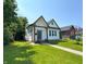 Charming home with craftsman-style architecture, lush lawn, and inviting curb appeal at 1818 N Cornell Ave, Indianapolis, IN 46202