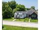 Charming home with a well-manicured lawn and beautiful trees at 1818 N Cornell Ave, Indianapolis, IN 46202