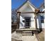 Close up of the home's covered porch with a modern black front door at 1818 N Cornell Ave, Indianapolis, IN 46202