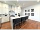 Modern kitchen with white cabinets, stainless appliances, and island with barstools at 1818 N Cornell Ave, Indianapolis, IN 46202