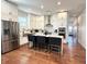 Bright kitchen with white cabinets, stainless steel appliances, and island with seating at 1818 N Cornell Ave, Indianapolis, IN 46202