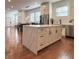 Open-concept kitchen with island, stainless steel appliances, and hardwood flooring at 1818 N Cornell Ave, Indianapolis, IN 46202