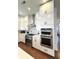 Gourmet kitchen featuring stainless steel appliances and white cabinets with black hardware at 1818 N Cornell Ave, Indianapolis, IN 46202