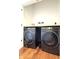 Modern black washer and dryer side by side on wooden floors at 1818 N Cornell Ave, Indianapolis, IN 46202