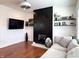 Cozy living room featuring a modern fireplace with decorative shelving, and neutral colored couches at 1818 N Cornell Ave, Indianapolis, IN 46202
