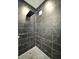 Elegant shower with black marble tiling and a rainfall shower head at 1818 N Cornell Ave, Indianapolis, IN 46202