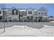 A row of modern townhouses in winter with snow-covered yards and architectural details at 2061 W 171St St, Westfield, IN 46074