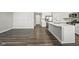 The kitchen features modern stainless-steel appliances, a sink in the island and hardwood floors at 2061 W 171St St, Westfield, IN 46074