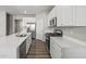Modern kitchen with stainless steel appliances, hardwood floors, white cabinets and gray walls at 2061 W 171St St, Westfield, IN 46074