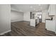 Open-concept living space with hardwood floors and modern kitchen featuring stainless steel appliances and a center island at 2061 W 171St St, Westfield, IN 46074