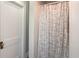 Bathroom with a white patterned curtain and an old door at 211 Jones St, Columbus, IN 47201