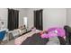 Bedroom with black out curtains, desk, and a decorated bed at 211 Jones St, Columbus, IN 47201