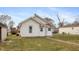 Shows the exterior of a white, single-Gathering home with a small yard and a sidewalk leading to the entrance at 211 Jones St, Columbus, IN 47201
