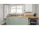 Functional kitchen with stainless sink and neutral color palette, providing everything needed for culinary adventures at 211 Jones St, Columbus, IN 47201