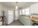 Bright kitchen featuring hardwood floors, a stainless sink, and fresh paint, providing functionality and charm at 211 Jones St, Columbus, IN 47201