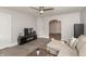 Relaxing living room with hardwood floors, a ceiling fan, and modern television, providing a cozy and comfortable ambiance at 211 Jones St, Columbus, IN 47201