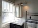 Modern bathroom with vanity, mirror, tile, and natural light at 230 E 9Th St # 506, Indianapolis, IN 46204