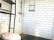 Modern bathroom featuring sleek white subway tile and built-in shelving for a clean and organized space at 230 E 9Th St # 506, Indianapolis, IN 46204