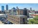 Urban view featuring a building with a fire escape and a city skyline in the background at 230 E 9Th St # 506, Indianapolis, IN 46204