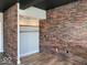Large closet features hardwood floors, brick accent wall, and open shelving at 230 E 9Th St # 506, Indianapolis, IN 46204