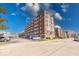 Brick apartment building featuring multiple stories and a parking lot on a sunny day at 230 E 9Th St # 506, Indianapolis, IN 46204