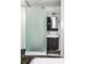 Modern bathroom with glass shower, dark wood vanity, white tile, and frosted privacy glass at 2417 E 80Th E St, Indianapolis, IN 46240