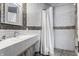 Bright bathroom featuring a white vanity, patterned tile accent, and shower with curtain at 2417 E 80Th E St, Indianapolis, IN 46240