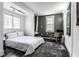 Bright bedroom with white bedding, area rug, modern chair, and natural light from a window at 2417 E 80Th E St, Indianapolis, IN 46240