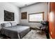 Bedroom featuring a full bed, reading chair, hardwood window trim, and wall art at 2417 E 80Th E St, Indianapolis, IN 46240