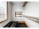 Walk-in closet with custom shelving, storage bench, and ample natural light, providing an organized and functional space at 2417 E 80Th E St, Indianapolis, IN 46240